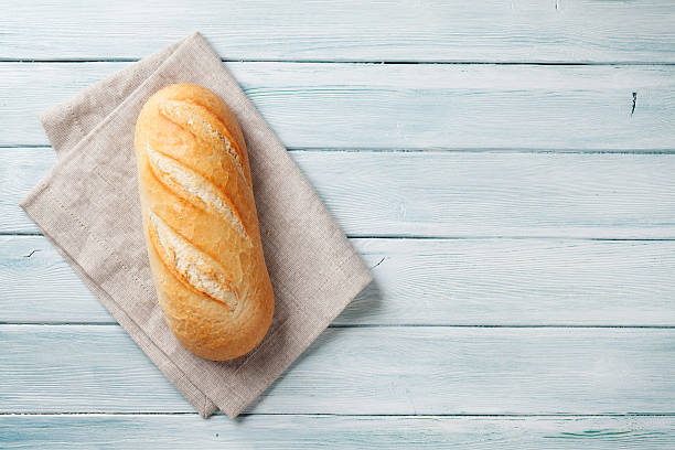 Fresh bread Fresh bread on wooden table. Top view with space for your text loaf of bread stock pictures, royalty-free photos & images