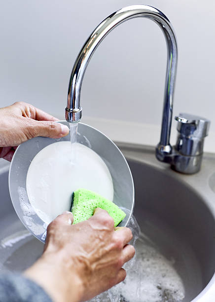 istock young man washing dishes 637765300