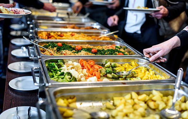 Cuisine Culinary Buffet Dinner Catering Dining Food Celebration Cuisine Culinary Buffet Dinner Catering Dining Food Celebration Party Concept. Group of people in all you can eat catering buffet food indoor in luxury restaurant with meat and vegetables. people banque stock pictures, royalty-free photos & images