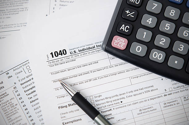 istock US tax form 1040 with pen and calculator 637765826