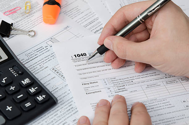 istock Man filling US tax form 637765852