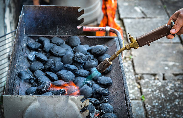 istock Firing up charcoal briquettes for the BBQ grill. 637765980