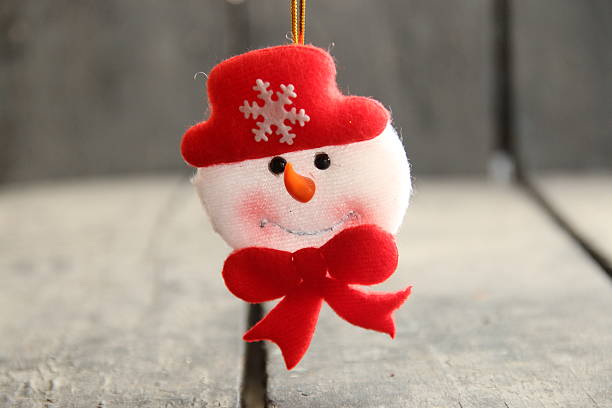 Snowman toy on rustic wooden background. Christmas and New Year celebration
