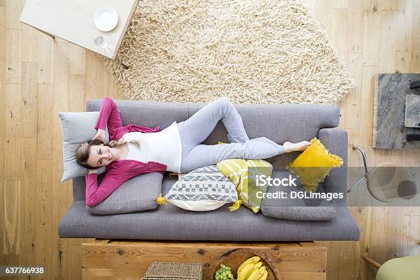 Woman Relaxing On Sofa Stock Photo - Download Image Now - Sofa, High Angle View, Women