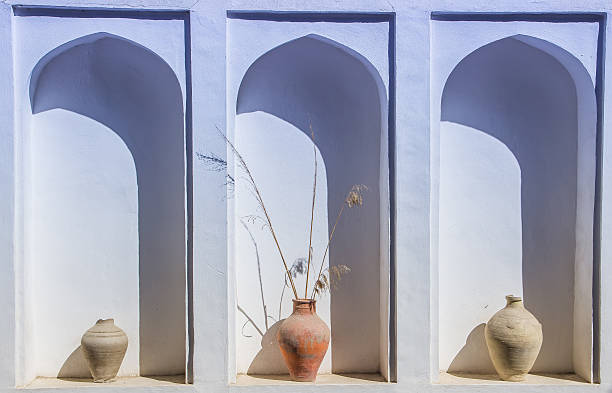 istock An arched niche in a wall with old clay vases 637767048