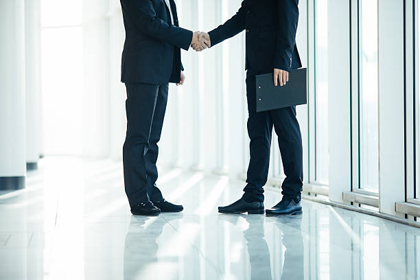 istock Close up of men handshake in office room 637767288