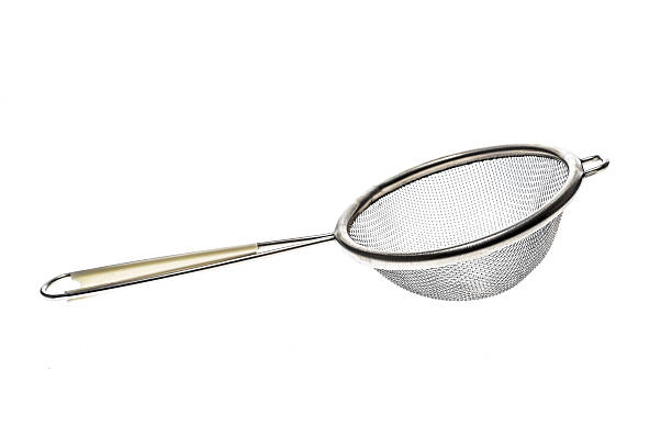 istock Small metallic tea strainer sieve with handle isolated on white. 637767360