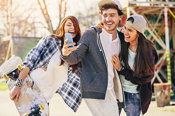 istock Cheerful skaters with phone on the playground 637767392