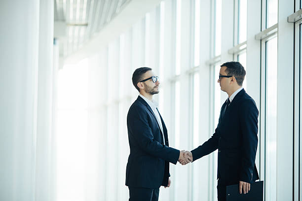 istock Boss and manager agree handshake in office panoramic room 637767448