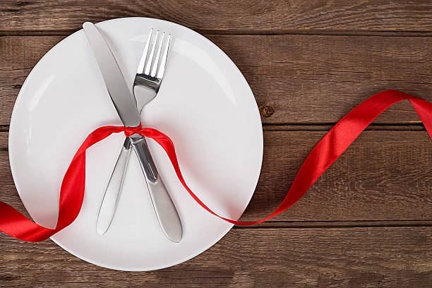 istock Valentines day table setting with plate, fork, knife and ribbon 637772208