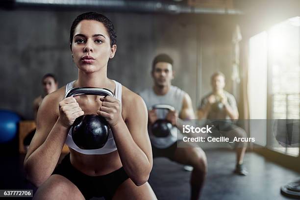 Burning Calories And Strengthening Her Core With A Kettlebell Stock Photo - Download Image Now