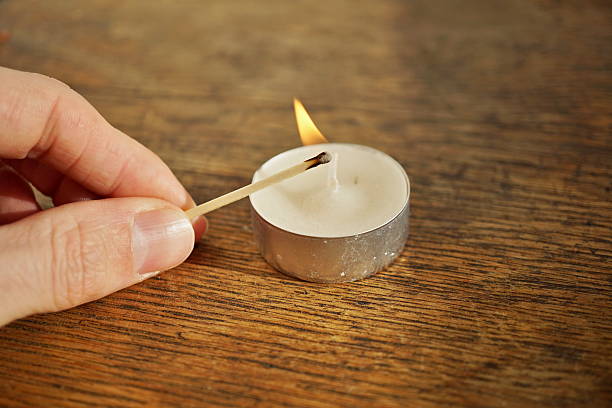 istock Male hand holding an ignited safety match stick 637773138
