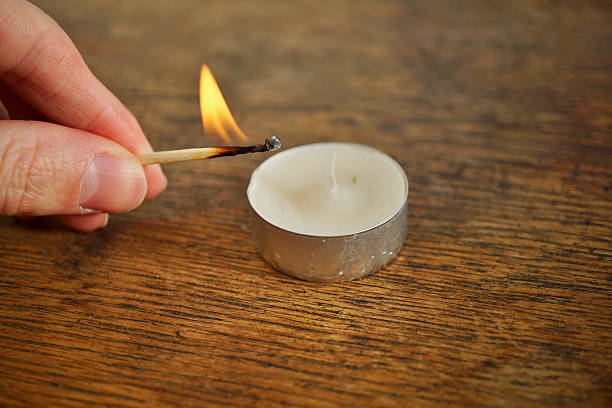 istock Male hand holding an ignited safety match stick 637773200
