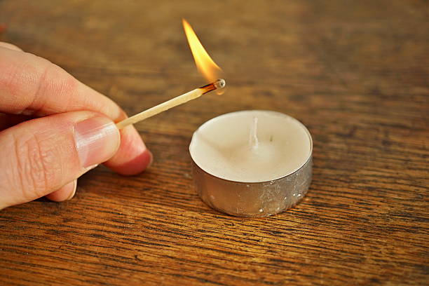 istock Male hand holding an ignited safety match stick 637773238