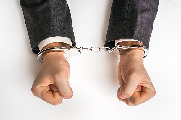 istock Male hands in handcuffs 637773636