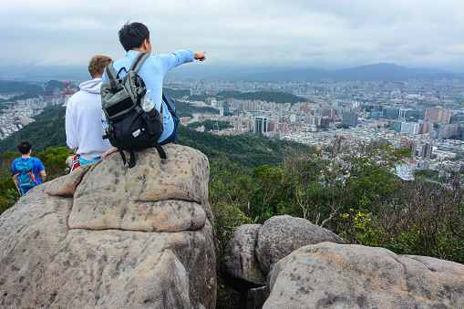 Taipei, Taiwan - January 8, 2017: A young Taiwanese man teaches a foreign student from Czech Republic about important Taipei landmarks and history.