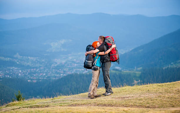 istock Hikers is embracing, standing on the road in the mountain 637777660
