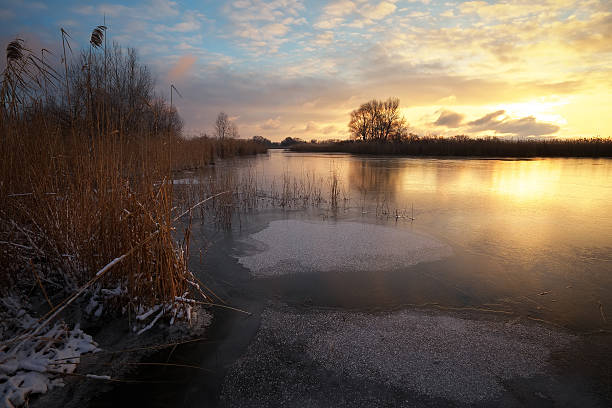 istock Winter landscape with sunset sky and frozen river. Daybreak 637778150