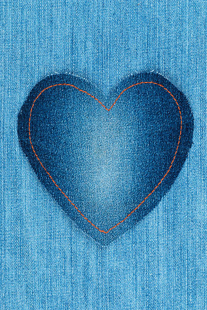 istock Heart made of denim fabric lies on light 637778184