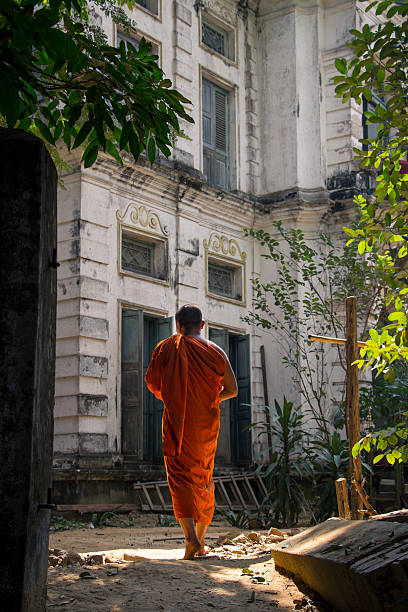 istock Buddhist monk is walking in front of an old building 637778664