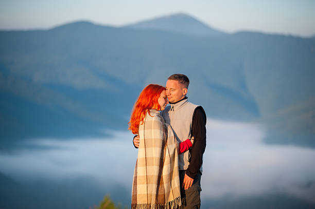 istock Lovely pair standing on a hill, embracing each other 637779472