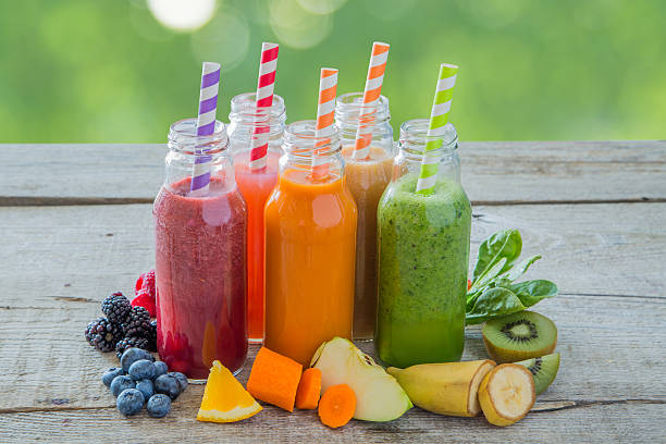 istock Selection of colourful smoothies on rustic wood background 637780150