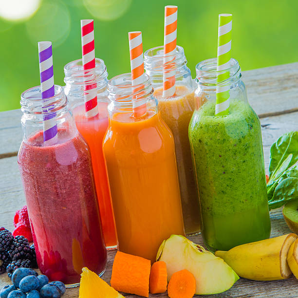 istock Selection of colourful smoothies on rustic wood background 637780216