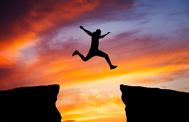 istock Man jumping across the gap 637781000