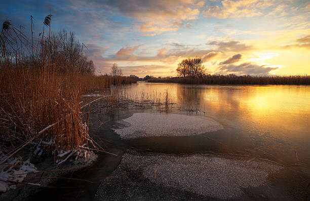 istock Winter landscape with sunset sky and frozen river. Daybreak 637781842