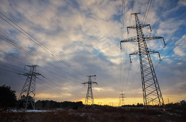 istock High-voltage power lines during fiery sunrise 637782002