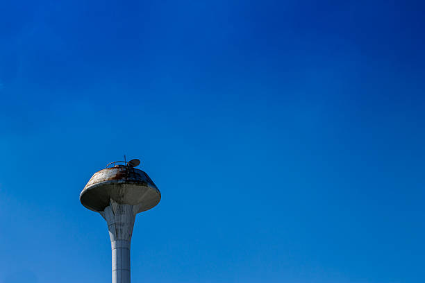 istock Water tank located isolately in front of cloudless sky. 637782838