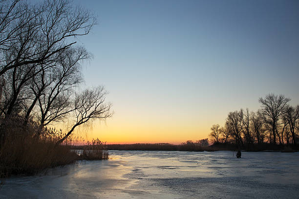 istock Winter landscape with sunset sky and frozen river. 637782988