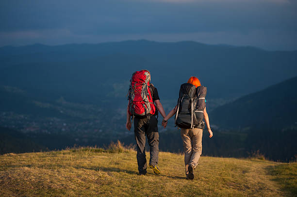 istock Back view of couple hikers with backpacks 637783086