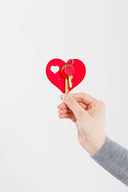 istock Female hand holds little heart with keys. 637783622