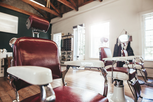 Hair salon interior with empty chairs. Retro styled barbershop.