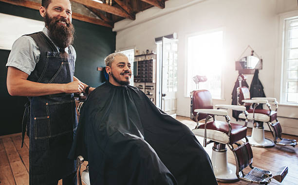istock Hipster man getting haircut at barber shop 637785794