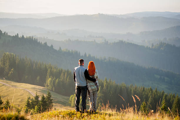 istock Hikers standing on a hill, enjoying beautiful mountain landscape 637788570