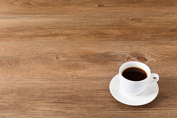 istock Cup of coffee in a white cup on wooden background 637788806