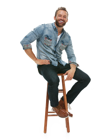 Smiling man sitting on stool