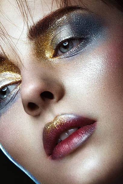 istock Beautiful girl with creative golden and silver glitter make-up 637789780