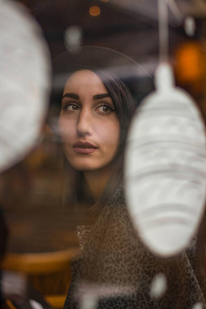 istock Woman Looking Out Of A Cafe Window 637791938