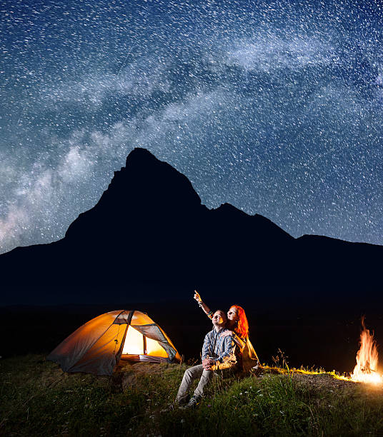 istock Girl and guy looking at the shines sky at night 637793624
