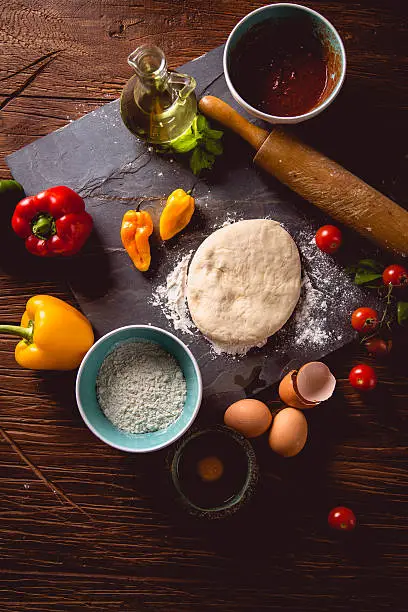 Photo of Fresh and tasty homemade pizza on wooden table with ingredients