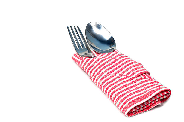 istock Red napkin with stainless spoon and fork on white background. 637793984