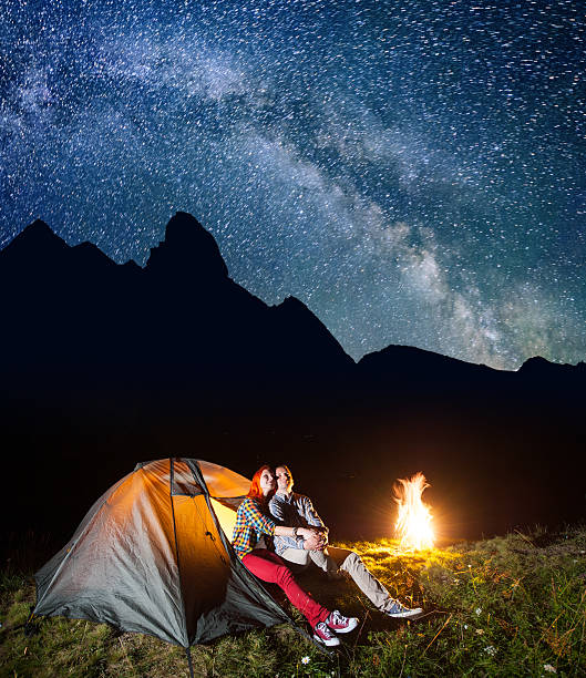 istock Pair lovers looking to the starry sky and Milky way 637794624