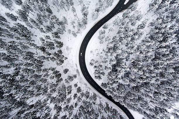 istock Road curve wintery forest aerial view snow 637797710