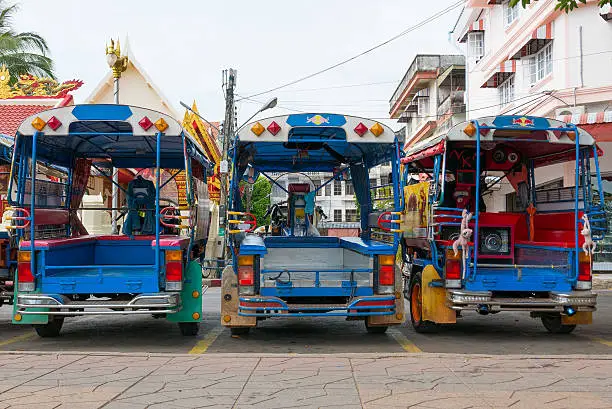 Photo of Rickshaws lined up in the street of Bankok, Thailand