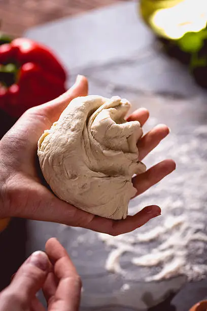 Photo of Young girl's hand knead the dough