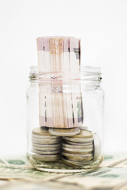 istock Banknotes and Coins in Glass Jar on Us Dollars 637800414