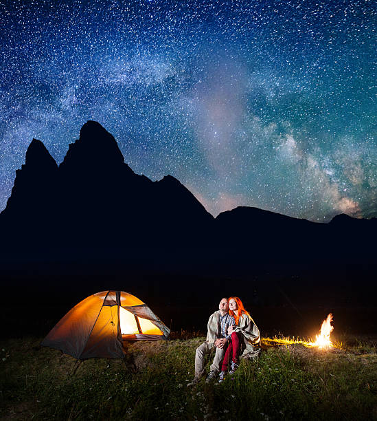 istock Two lovers tourists covered with a plaid sitting together 637800570